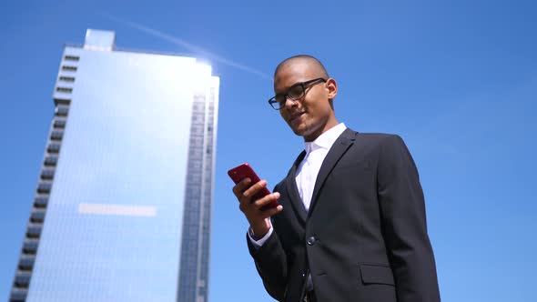 Businessman Using Mobile Phone Outdoors. Business And Technology Concept