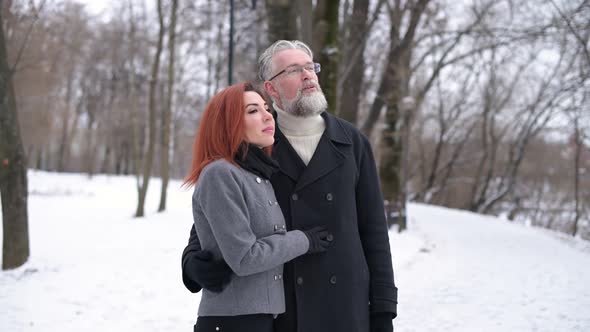 Husband and wife walk in the park and enjoy the views, contemplate the landscape