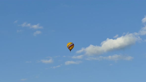 Hot air balloon moving towards the clouds