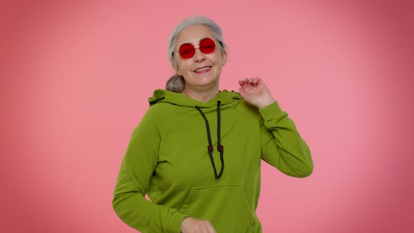 Elderly Granny Grandmother Woman in Sunglasses Listening Music Smiling Dancing to Music Having Fun