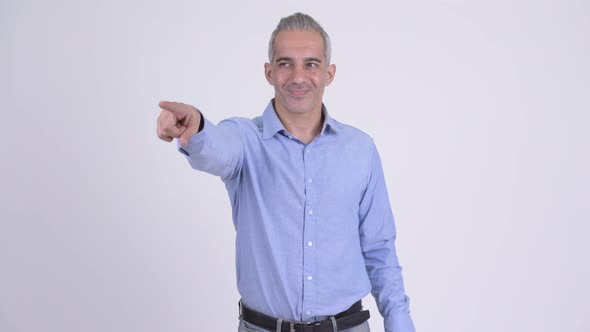 Happy Persian Businessman Pointing Finger Against White Background