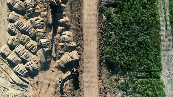 Building a road from a height using a roller and excavator - copter footage