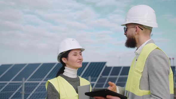 Close Up of Ecological Engineers Use Digital Tablet and Talk at the Powerhouse