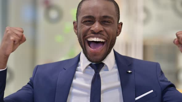 Portrait of Excited African Businessman Celebrating Success