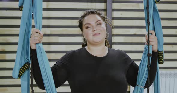 Happy Body Positive Woman Smiling and Laughing After Doing Stretching Exercise on Hammocks