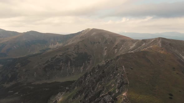 Mountain Ridge Under Cloudy Sky in Summer