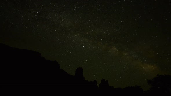 Shooting star streaking across star filled night sky