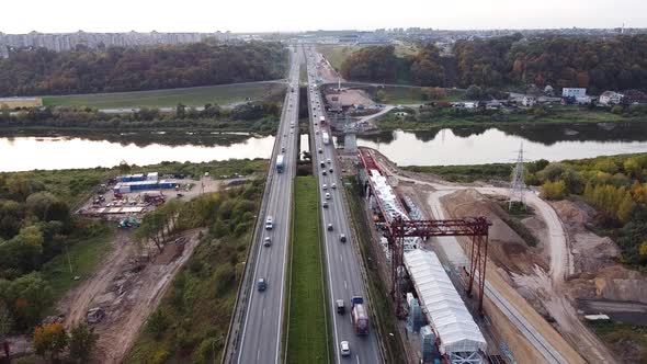 The A1 highway bridge over river Neris in Kaunas, Lithuania in drone aerial static shot. Heavy traff