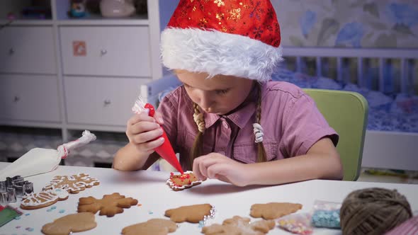 Child decorates gingerbread cookies