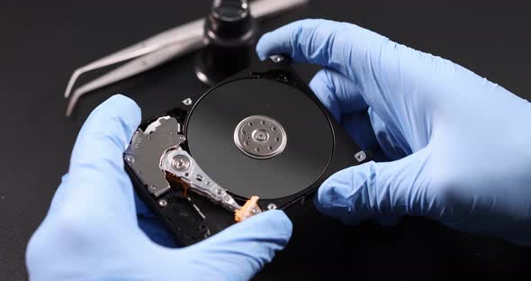 Gloved Master Holds Computer Hard Drive  Movie