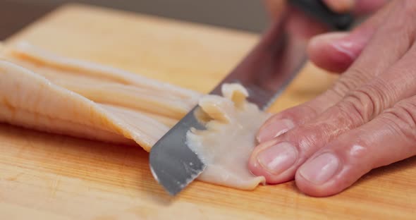 Cutting Fresh Geoduck on wooden board