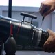 Using a screwdriver to remove screws on the barrel of a big movie camera zoom lens - VideoHive Item for Sale