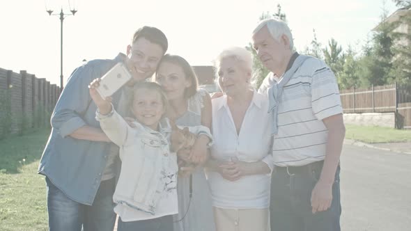 Little Girl Taking Selfie of Family