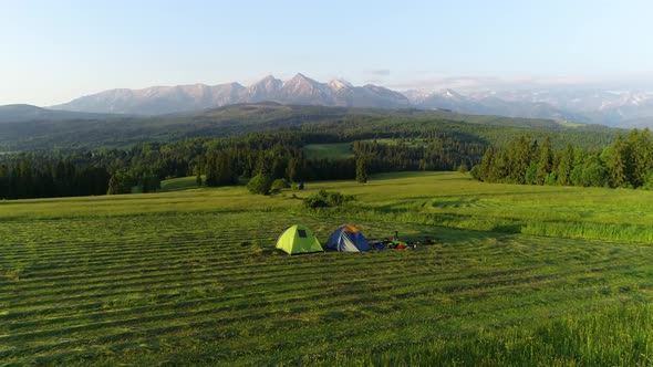 Camp in the mountains. Two tents with high mountains view. Concept: nomads, outdoor travelling, hike