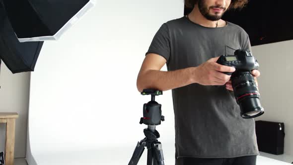 Photographer looking at photos on digital camera