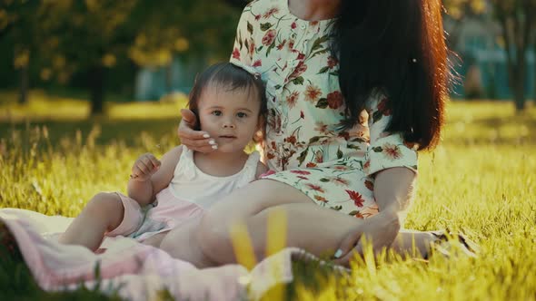 Little Girl with Her Mother on Nature