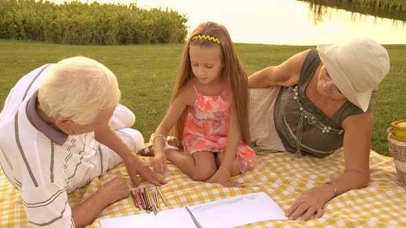 Little Girl Is Drawing Outdoors.