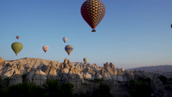Cappadocia, Turkey: Drone shot of many hot air balloon flying over idyllic Love Valley