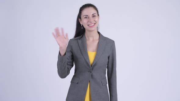 Happy Young Beautiful Businesswoman Waving Hand