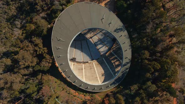 Aerial top down rising over Quinta Vergara Amphitheater surrrounded by autumnal forest in hillside p