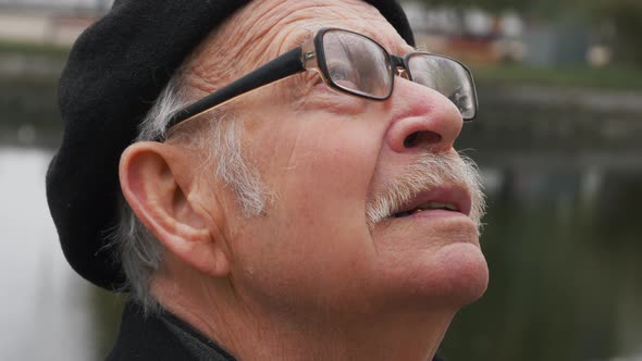 close up portrait of handome old man looking up praying exploring spirituality contemplating future