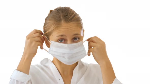 Business Lady Walking and Putting Medical Mask on on White Background.