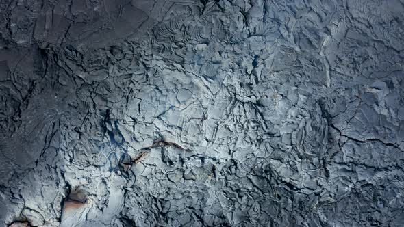 Spectacular Spiral Up Aerial Birds Eye Overhead Top Down View of Black Lava Lake Texture From Small