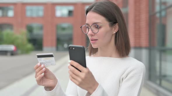 Young Woman having Online Payment Success on Smartphone
