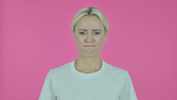 Sad Young Woman Isolated on Pink Background