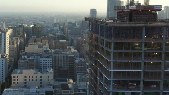 AERIAL: Flying Towards Construction Site Skyscraper in Downtown Los Angeles, California Skyline at