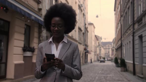 African Business Lady Using Smartphone on Street