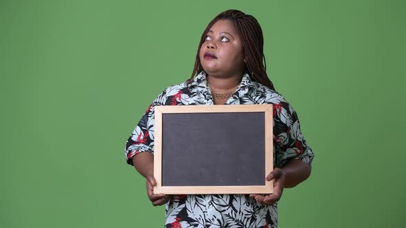 Overweight Beautiful African Woman Against Green Background