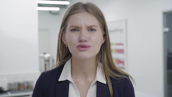 Portrait of Attractive Pretty Woman in Formal Wear Looking in Camera Asking for Help, Begging