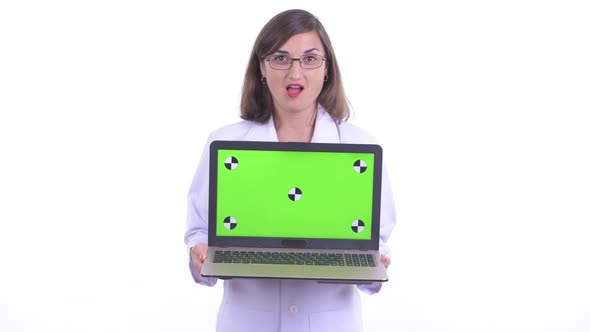 Happy Beautiful Woman Doctor Talking While Showing Laptop