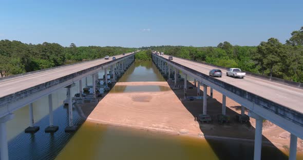 Aerial of cars driving on bridge that crosses over the San Jacinto River in Houston, Texas