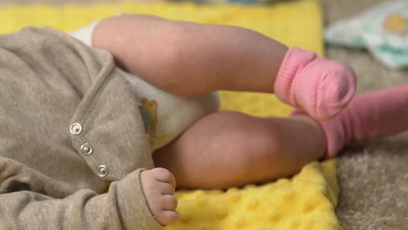 Tiny Adorable Baby Girl Lying on Draw-Sheet While Mother Is Busy, Lack of Time