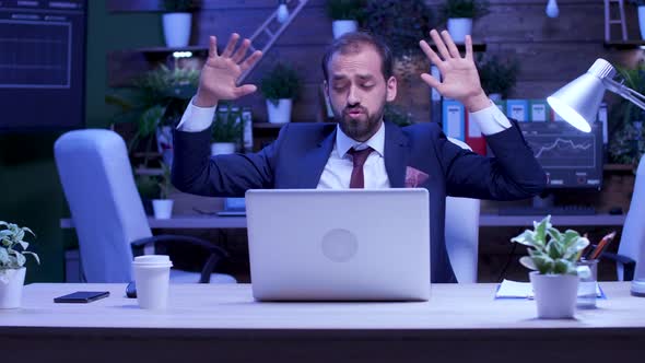 Happy and Excited Businessman in Formal Suit Dances at the Office Late at Night