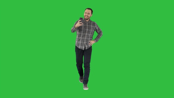 Cheerful bearded man taking selfie on a Green Screen, Chroma Key.