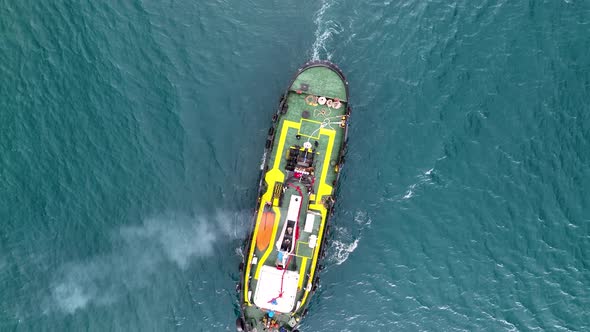 Ship tug sails out of port aerial view