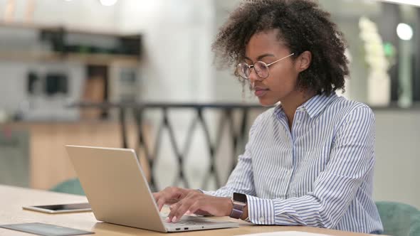 Positive Young African Businessman with Laptop Doing Thumbs Up