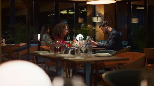 Mixed Race Couple Eating Enjoying Restaurant Food Meal on Night Dinner Date