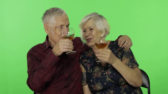 Senior Aged Man Drinking White Wine with a Elderly Woman Companion on Chroma Key