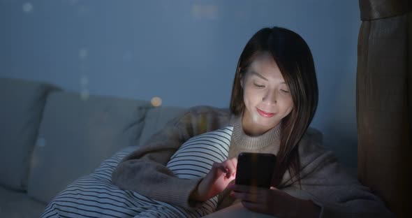 Woman work on mobile phone at night