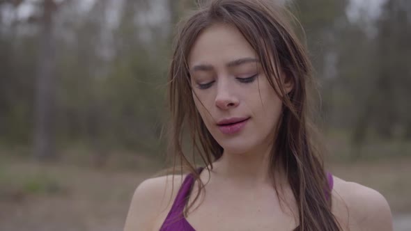 Close-up of Young Gorgeous Sportswoman Drinking Water in Park and Leaving