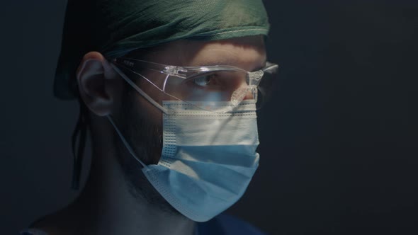 Medical surgeon operates in the operating room with glasses