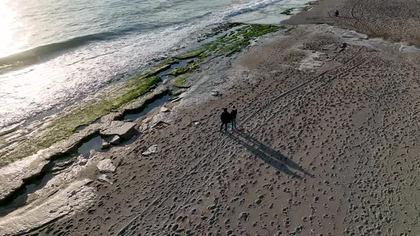 A couple walking on the beach