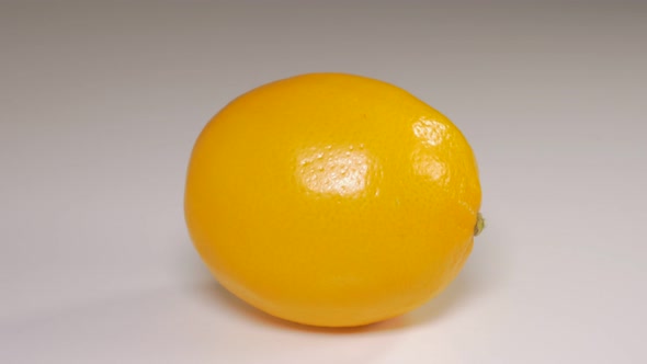 Lemon on white reflective background  dolly 4K 2160p UHD video - Yellow fresh lemon  on reflective s