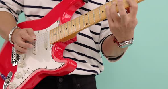 Slow motion close up musician playing the electric guitar during a live performance.