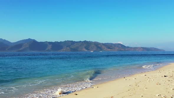 Natural flying copy space shot of a sunshine white sandy paradise beach and aqua blue water backgrou