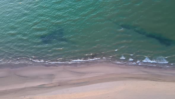 Sea waves top aerial view tracking left